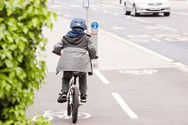 Child riding a bike along portsmouth road kingston
